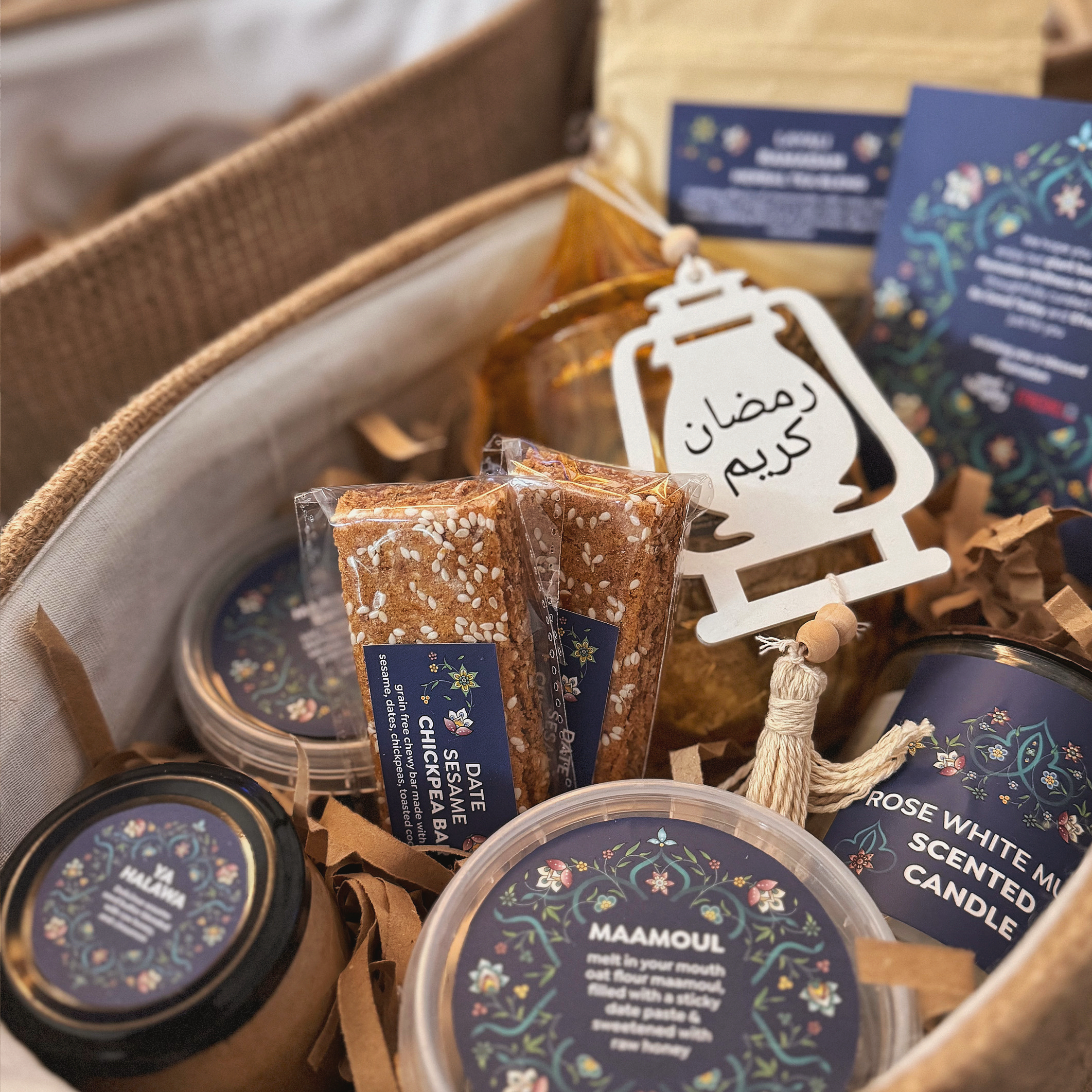 Gift basket with Ramadan-themed products including candles and cookies.